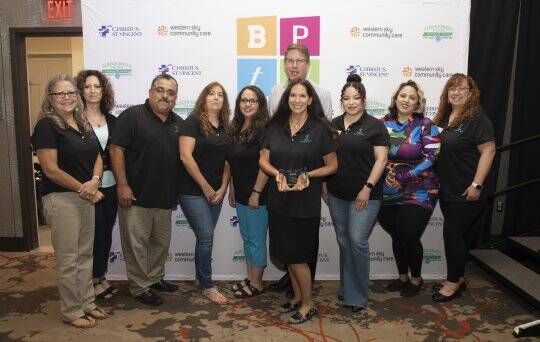 Housing NM Staff showcasing award after ranking in top 5 of the 2023 Best Places to work.