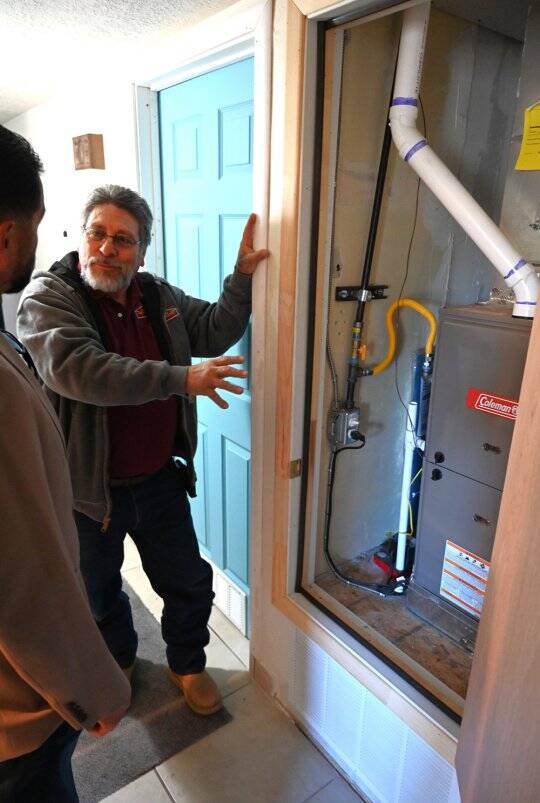 Manuel Padilla, with Central New Mexico Housing Corporation, describes the high-efficiency furnace.